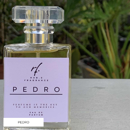 Perfume bottle labeled 'Pedro' with a clear glass design on a blurred natural background